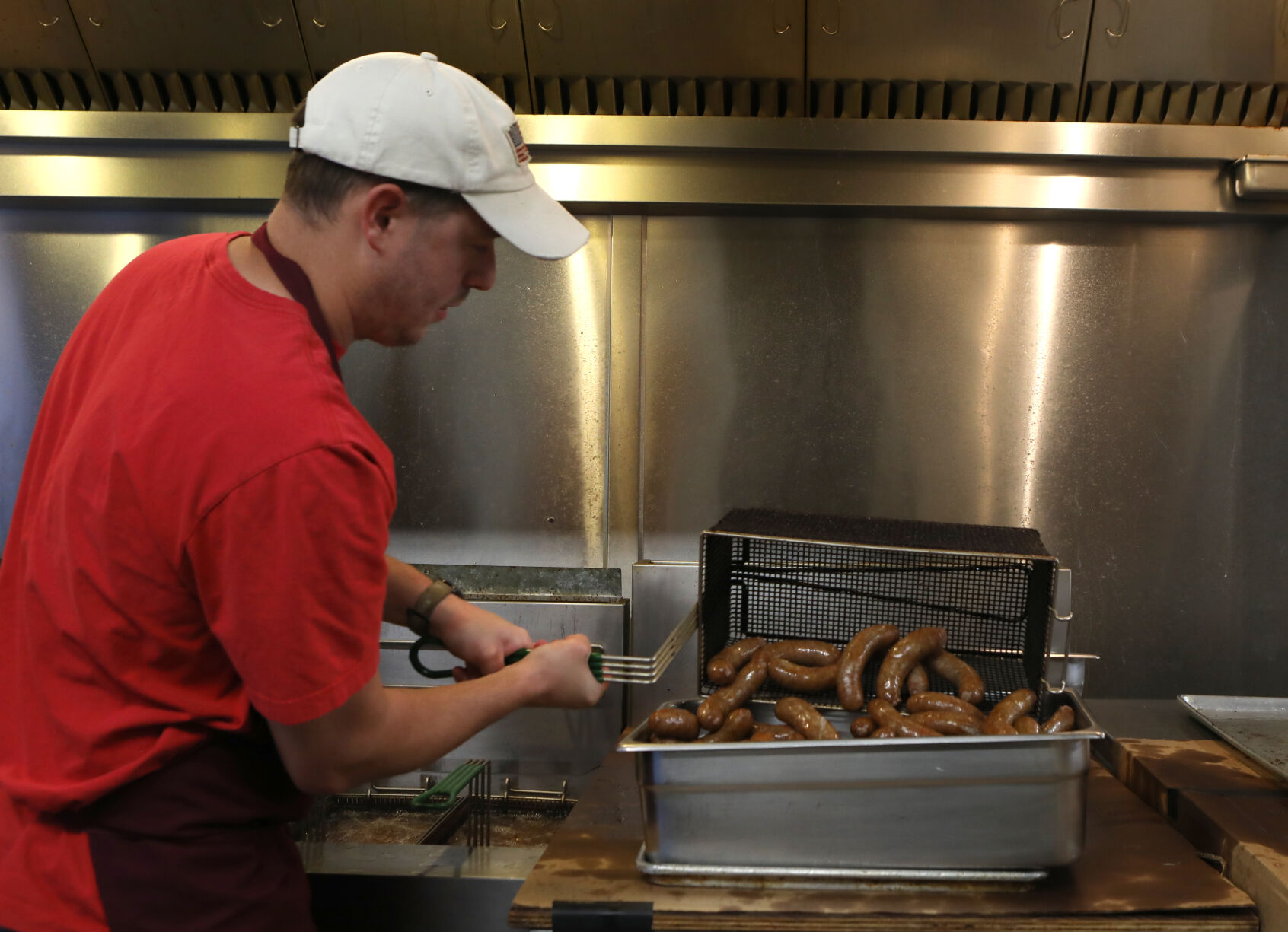 John Halmich cooks sausages